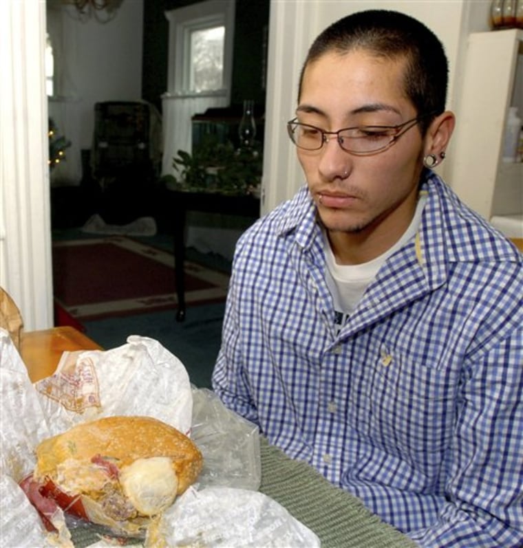 In this Dec. 6, 2007 file photo, Van Miguel Hartless looks at the Burger King sandwich he claims contained an unwrapped condom in it. 